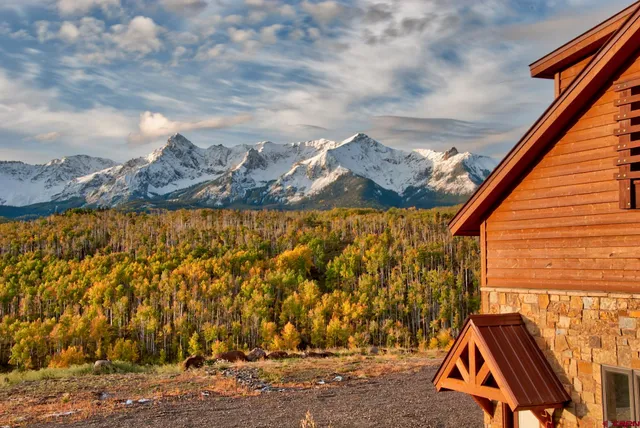 a view of a yard with wooden fence