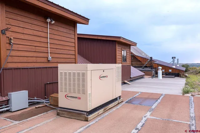 a view of a house with a yard and mountain view