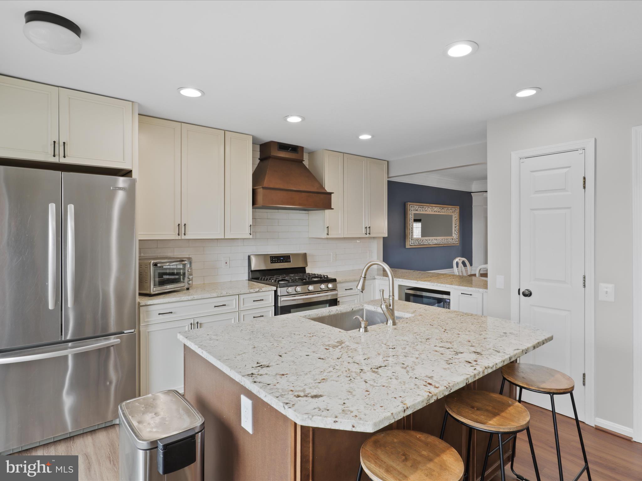 43271 Chokeberry Square Ashburn, VA 20147 - Photo 12 of 45 a kitchen with stainless steel appliances granite countertop a sink refrigerator and microwave