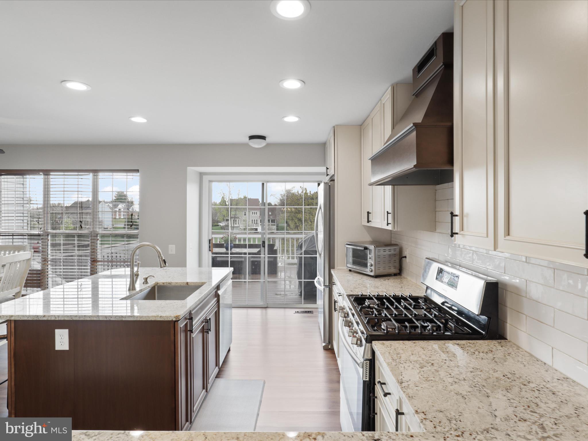 43271 Chokeberry Square Ashburn, VA 20147 - Photo 14 of 45 a kitchen with stainless steel appliances granite countertop a sink stove and cabinets
