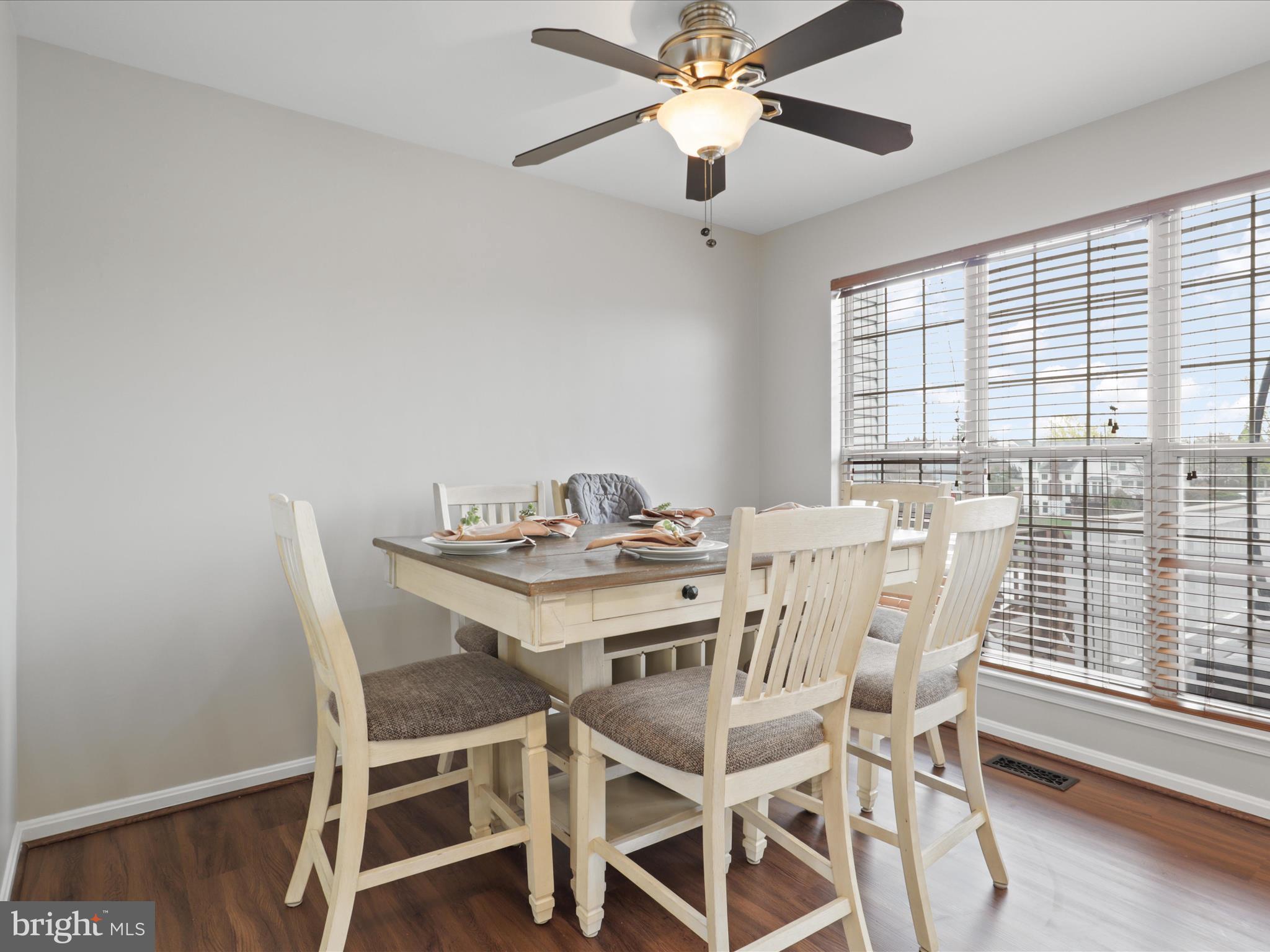 43271 Chokeberry Square Ashburn, VA 20147 - Photo 15 of 45 a view of a dining room with furniture window and wooden floor