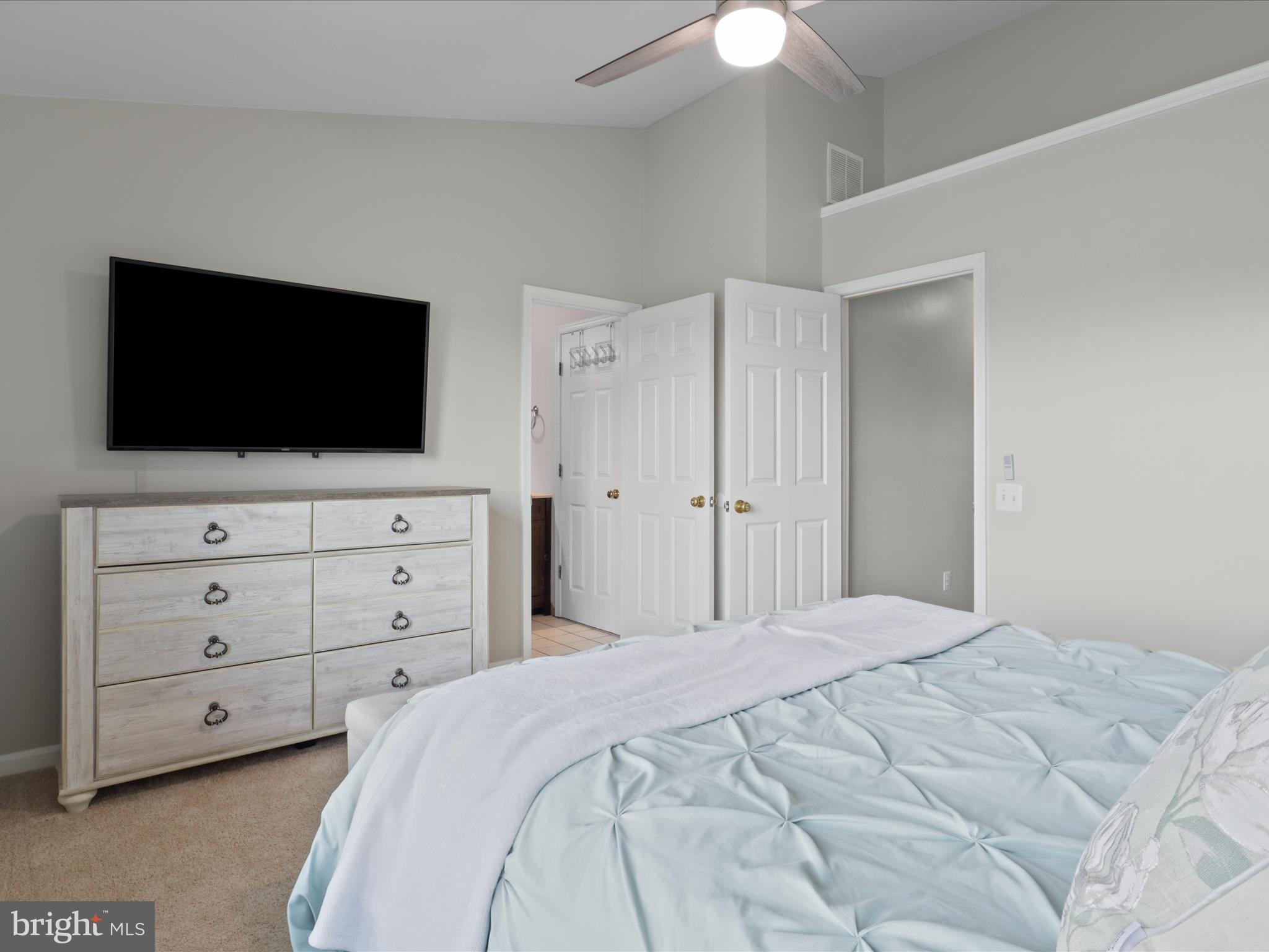 43271 Chokeberry Square Ashburn, VA 20147 - Photo 18 of 45 a bedroom with a bed and a flat screen tv