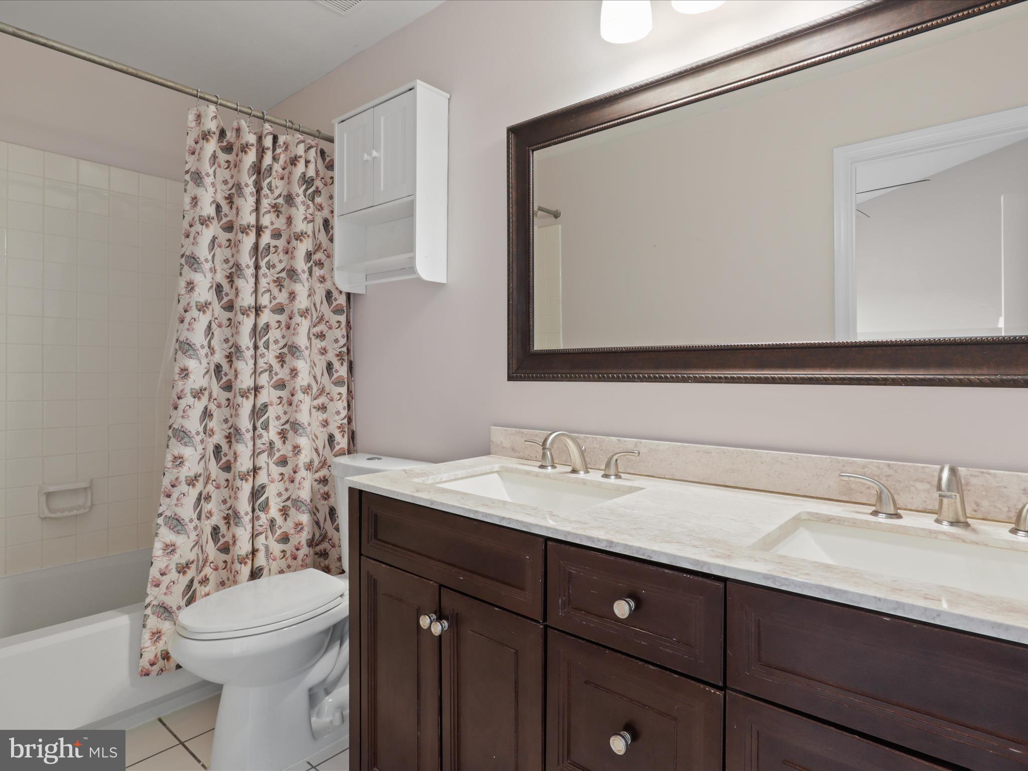 43271 Chokeberry Square Ashburn, VA 20147 - Photo 19 of 45 a bathroom with a sink a toilet and a mirror