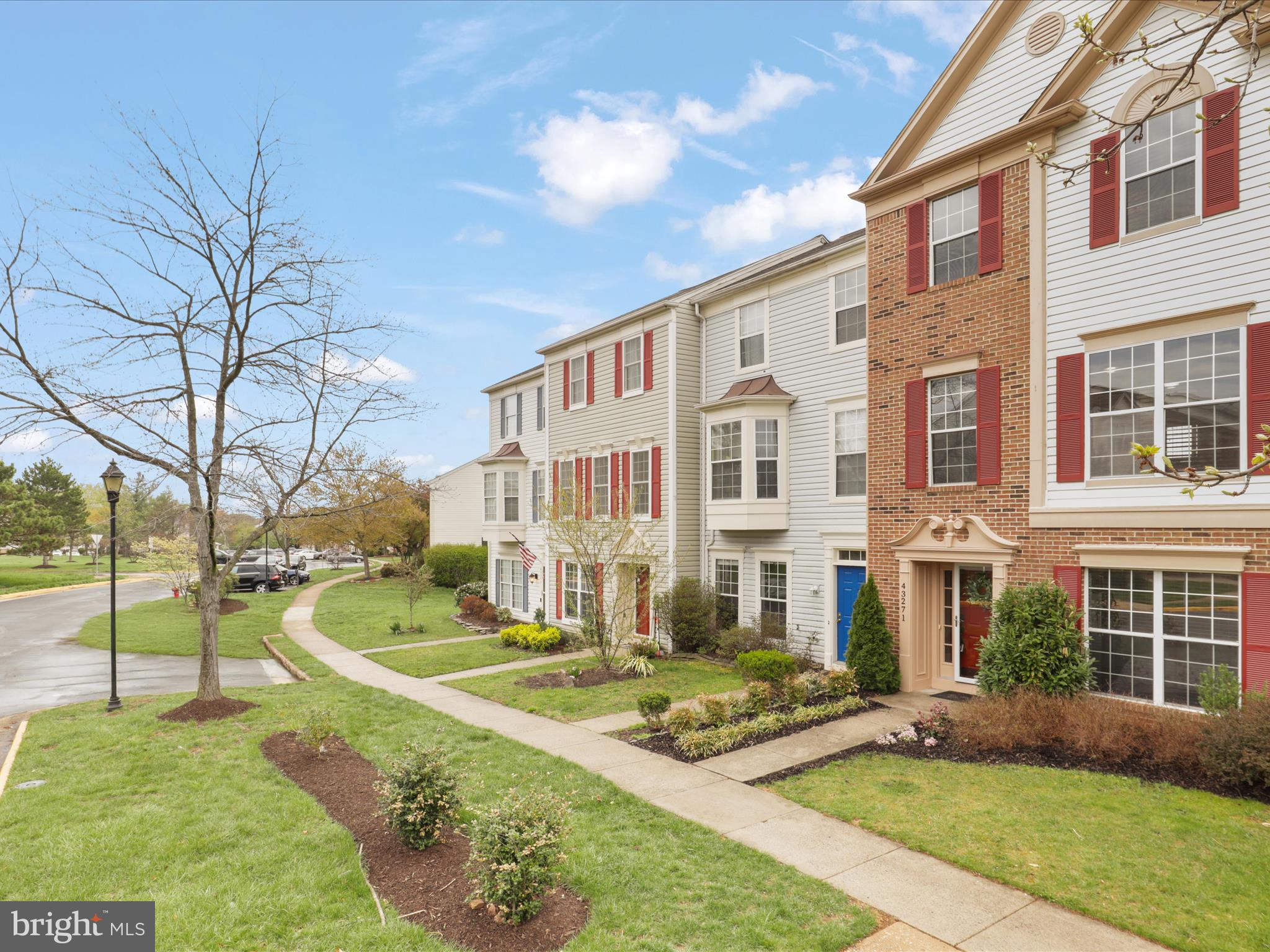 43271 Chokeberry Square Ashburn, VA 20147 - Photo 2 of 45 a front view of a building with garden and trees