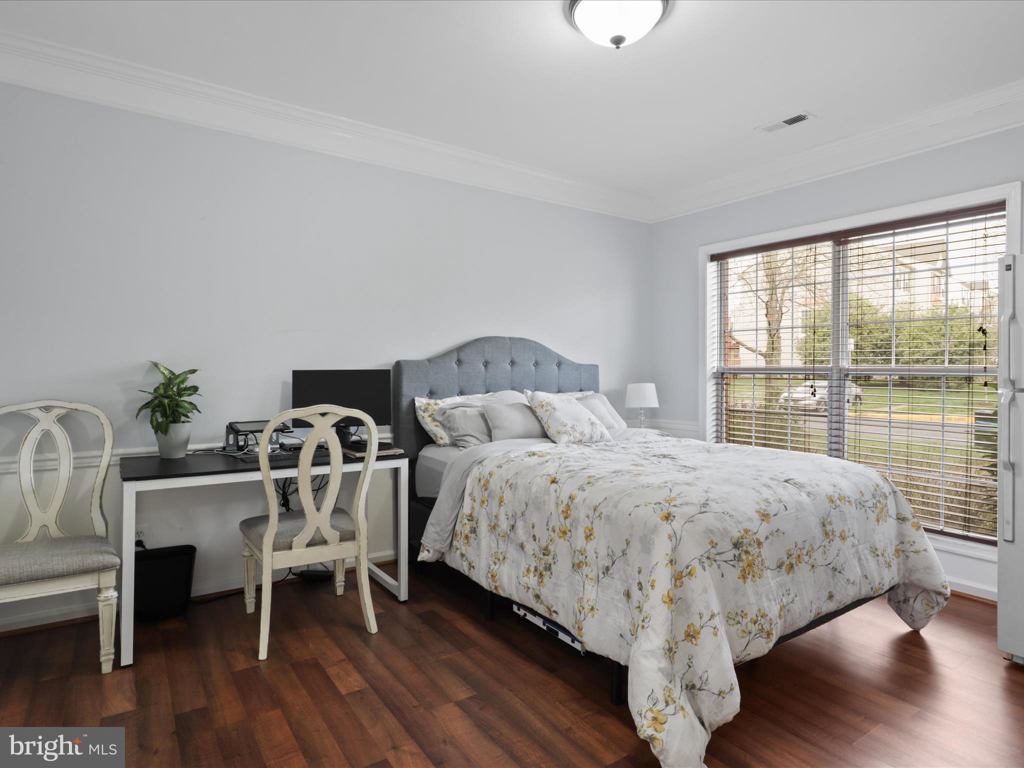 43271 Chokeberry Square Ashburn, VA 20147 - Photo 26 of 45 a bedroom with a bed and a table