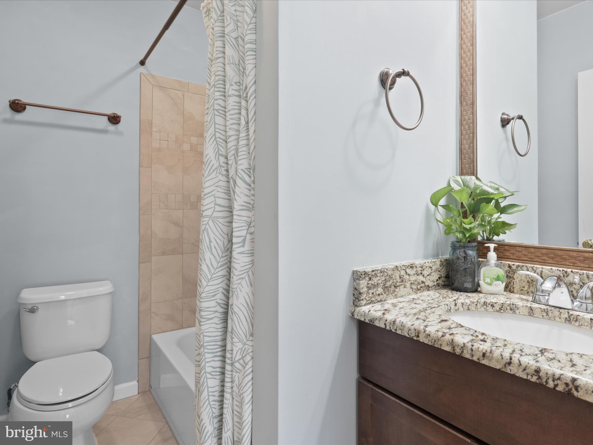 43271 Chokeberry Square Ashburn, VA 20147 - Photo 28 of 45 a bathroom with a granite countertop sink a toilet and shower