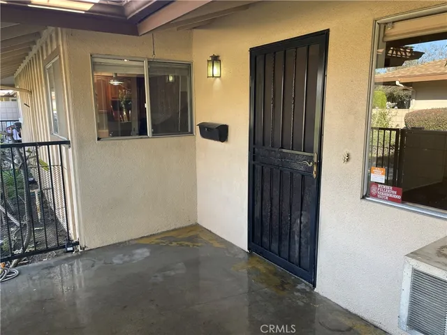 a view of livingroom with kitchen island hardwood floor and a ceiling fan