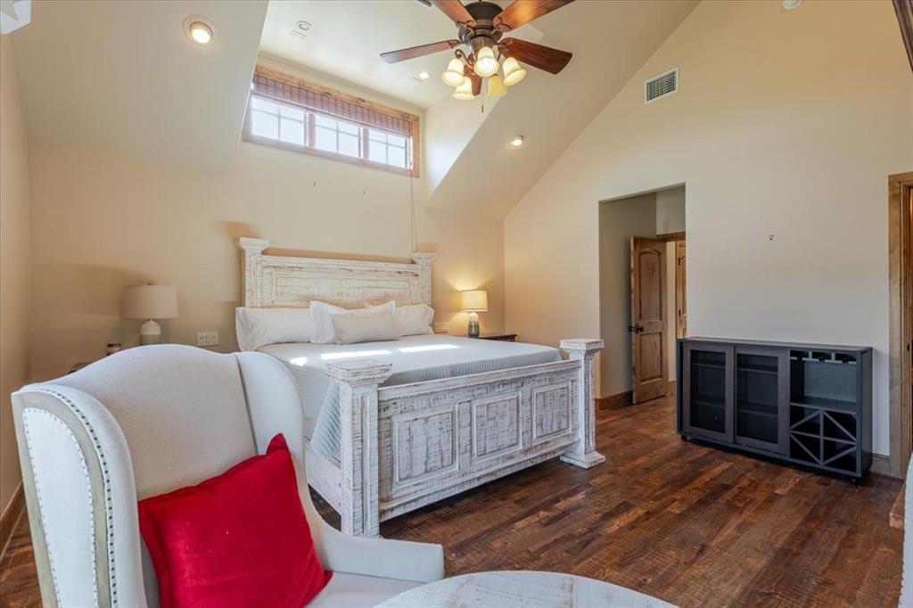 2034 Harbor Way, Unit 601 Graford, TX 76449 - Photo 16 of 27 a bedroom with a bed and a chandelier