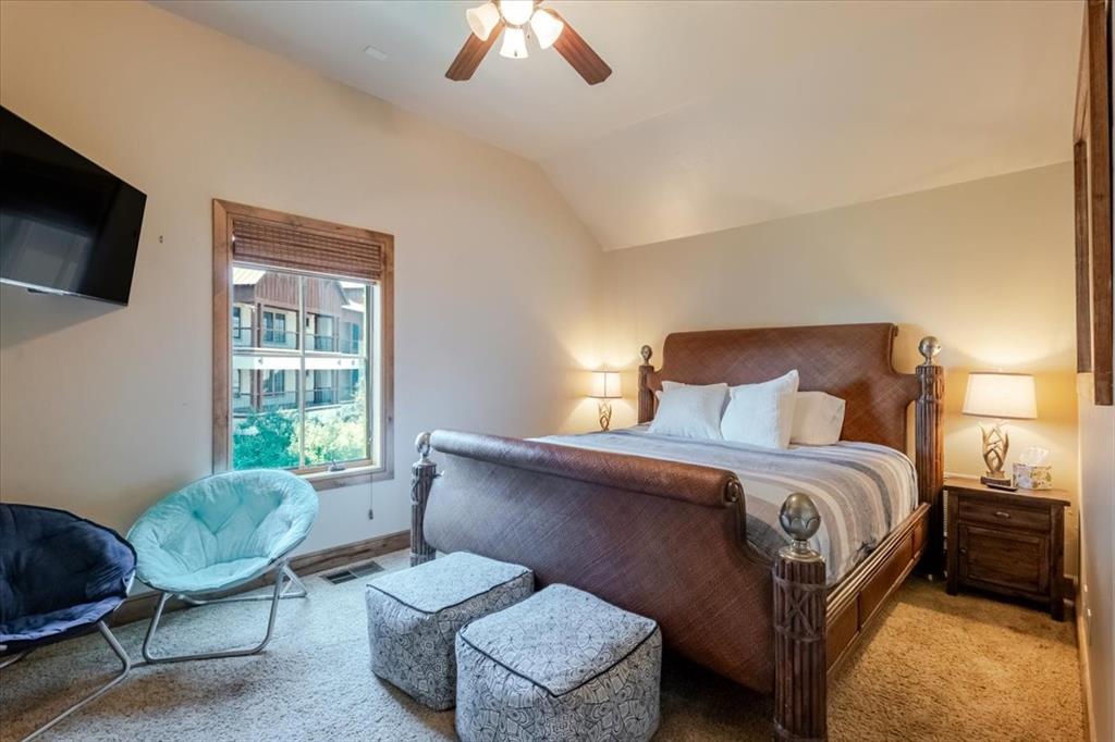 2034 Harbor Way, Unit 601 Graford, TX 76449 - Photo 19 of 27 a bedroom with a bed chair and a window