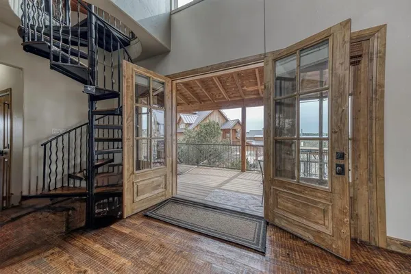 a view of a patio with table and chairs with wooden floor and fence