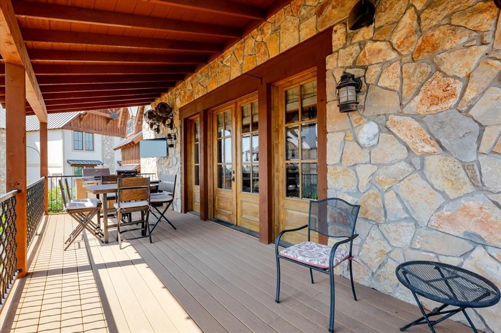 2034 Harbor Way, Unit 601 Graford, TX 76449 - Photo 25 of 27 a balcony with couple of chairs and wooden floor