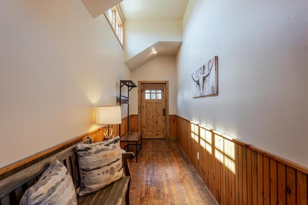 2034 Harbor Way, Unit 601 Graford, TX 76449 - Photo 4 of 27 a view of a hallway with wooden floor and staircase