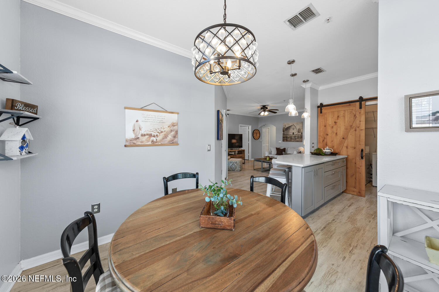 10961 Burnt Mill Road, Unit 317 Jacksonville, FL 32256 - Photo 15 of 39 a view of a dining room with furniture a chandelier and wooden floor
