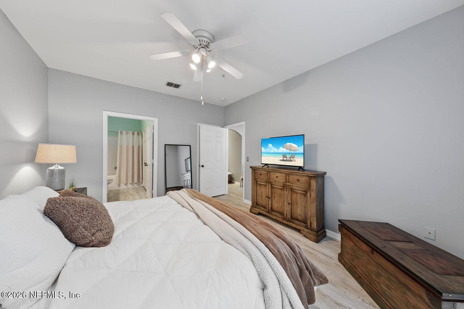 10961 Burnt Mill Road, Unit 317 Jacksonville, FL 32256 - Photo 17 of 39 a bedroom with a bed and a chandelier