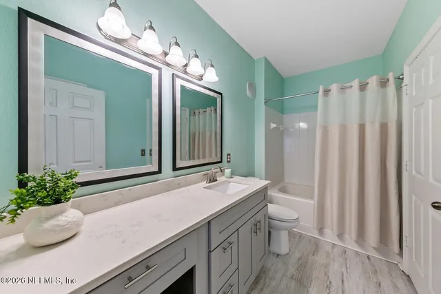 a view of walk in closet with clothes