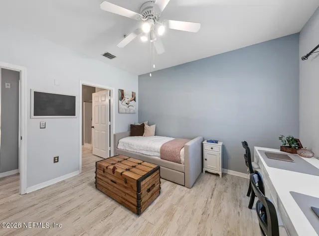 a bathroom with a granite countertop sink a toilet and a mirror