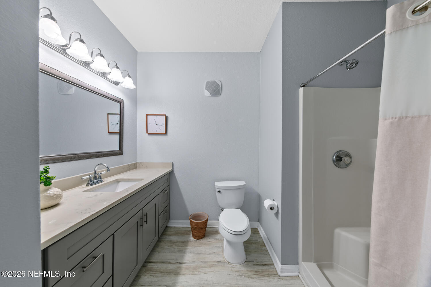 10961 Burnt Mill Road, Unit 317 Jacksonville, FL 32256 - Photo 22 of 39 a bathroom with a granite countertop sink a toilet and a mirror