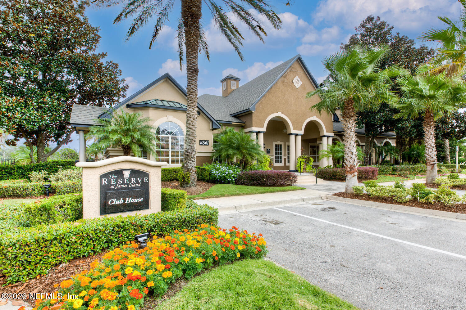 10961 Burnt Mill Road, Unit 317 Jacksonville, FL 32256 - Photo 25 of 39 a front view of a house with a yard and garden