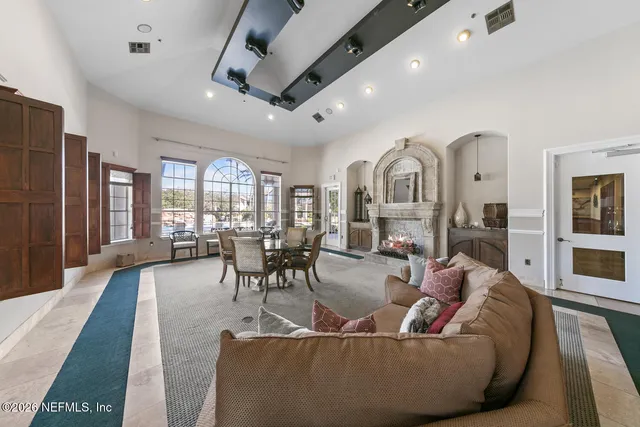 a living room with fireplace furniture and a large window