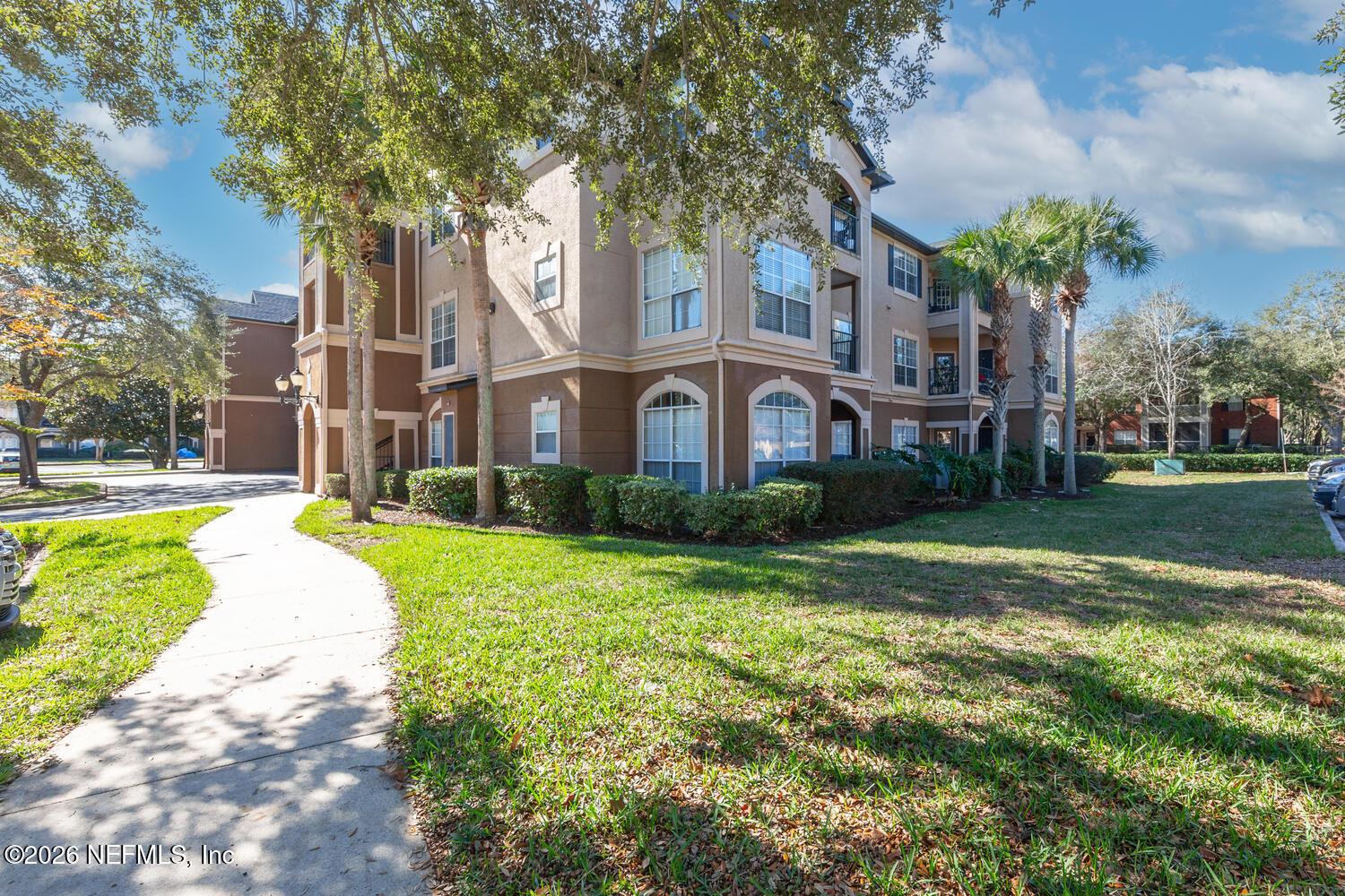 10961 Burnt Mill Road, Unit 317 Jacksonville, FL 32256 - Photo 38 of 39 a view of a house with a big yard and large trees