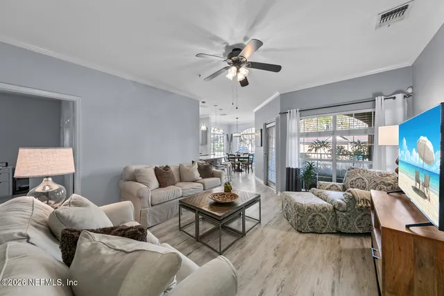 a living room with furniture and a flat screen tv