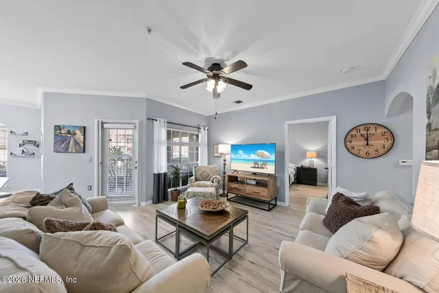 a living room with furniture a couch and a window