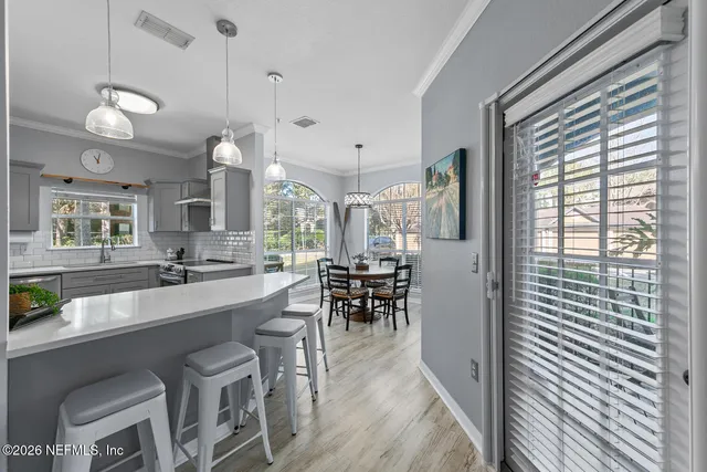 a large kitchen with a table and chairs