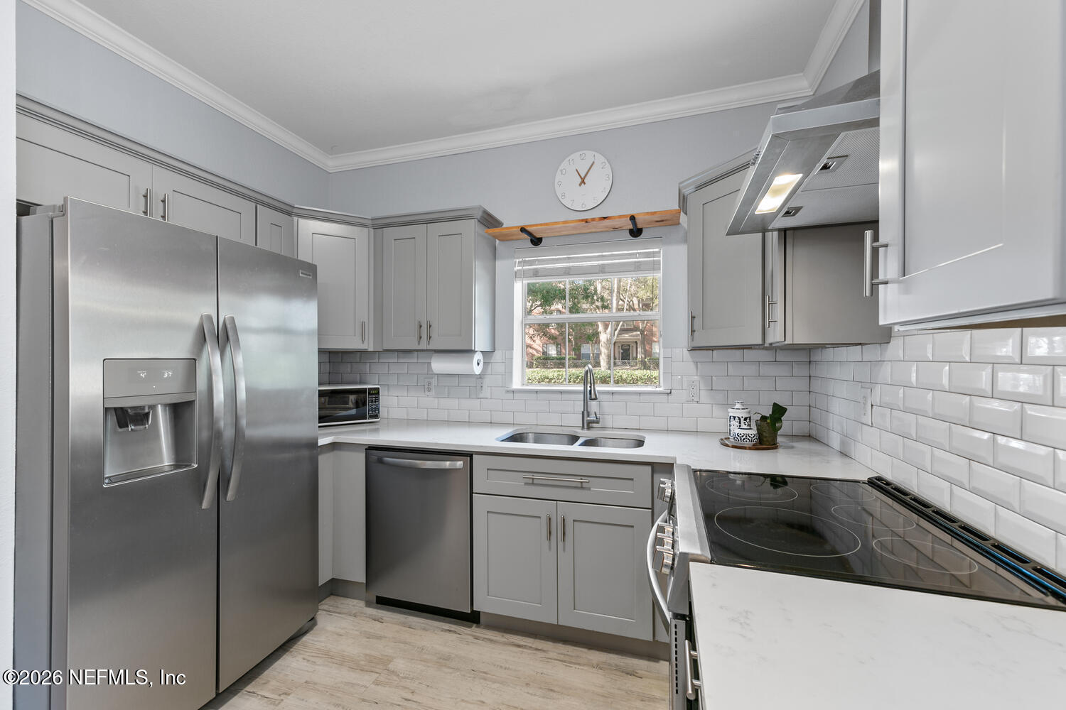 10961 Burnt Mill Road, Unit 317 Jacksonville, FL 32256 - Photo 10 of 39 a kitchen with a sink a refrigerator and cabinets