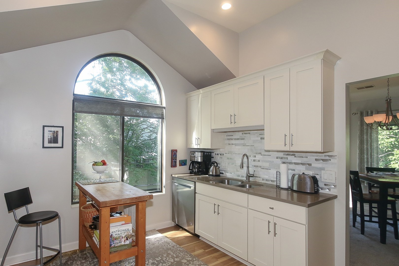 942 Shoreline Road, Unit 907 Lake Barrington, IL 60010 - Photo 5 of 28 a kitchen with stainless steel appliances granite countertop a stove a sink a refrigerator and white cabinets with wooden floors