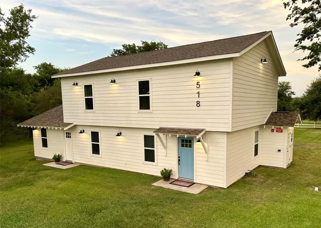 a front view of a house with a yard