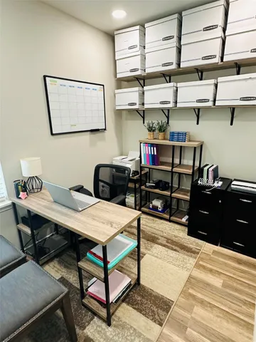 a bedroom with a bed a desk and chair