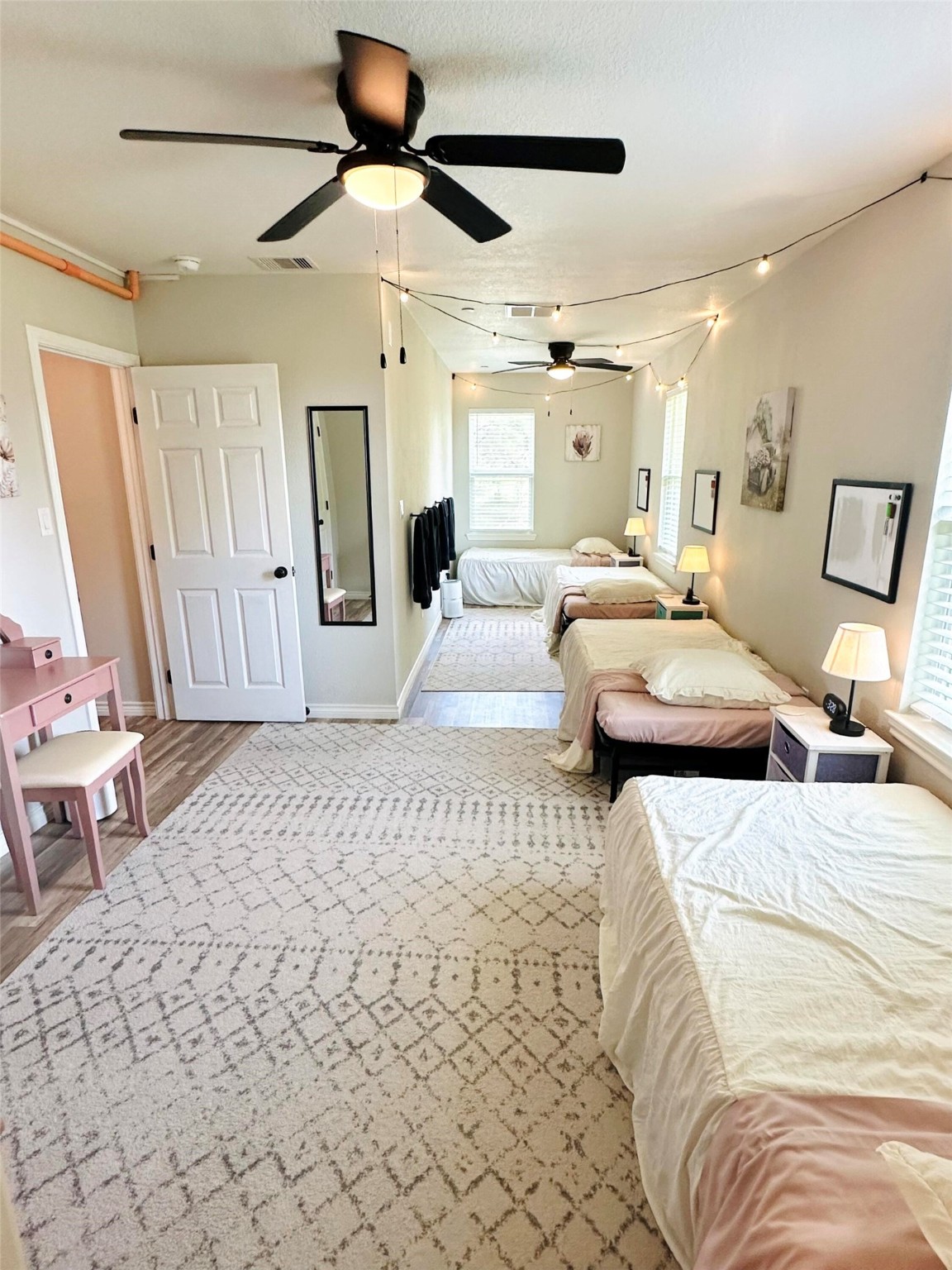 518 Anton Stade Road Rosenberg, TX 77471 - Photo 20 of 37 a bedroom with a large bed and a chandelier