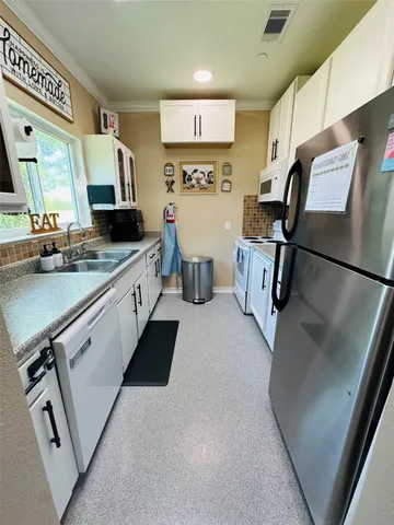 a kitchen with a refrigerator and a sink