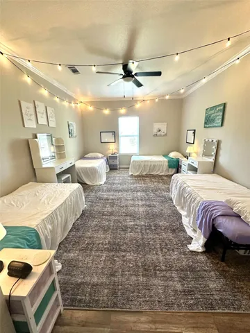 a spacious bedroom with two beds and a chandelier