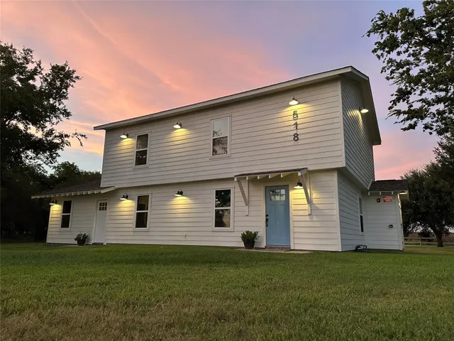 a front view of a house with a yard