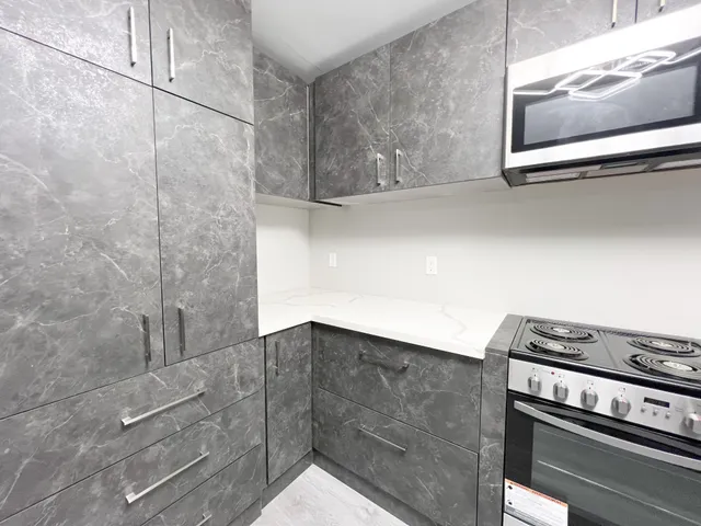 a kitchen with a stove and a microwave