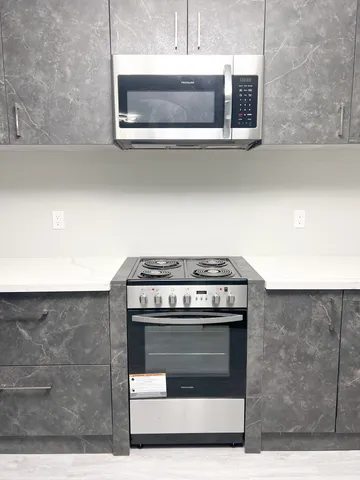 a stove top oven sitting inside of a kitchen