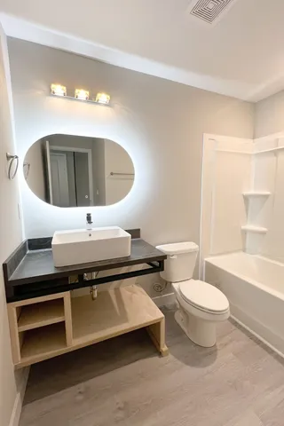 a bathroom with a toilet a sink and bathtub