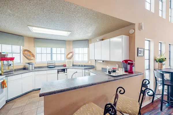 a kitchen with granite countertop a sink and cabinets