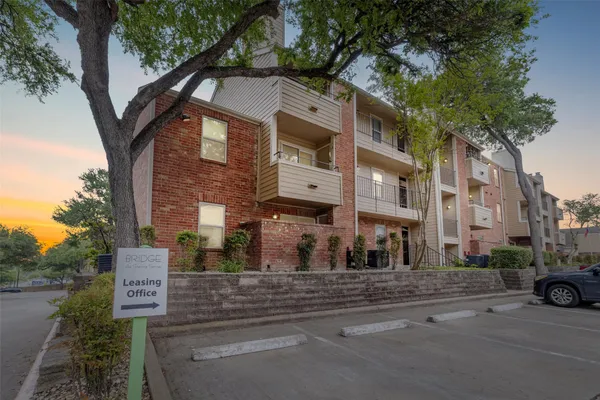 a front view of a building with parking area
