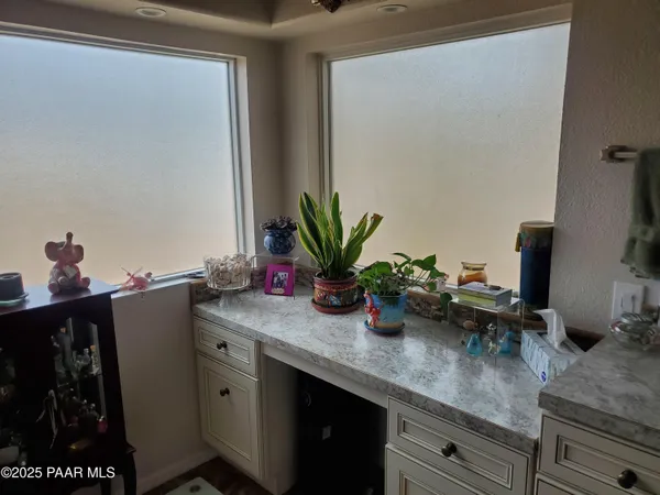 a kitchen with sink and view of living room