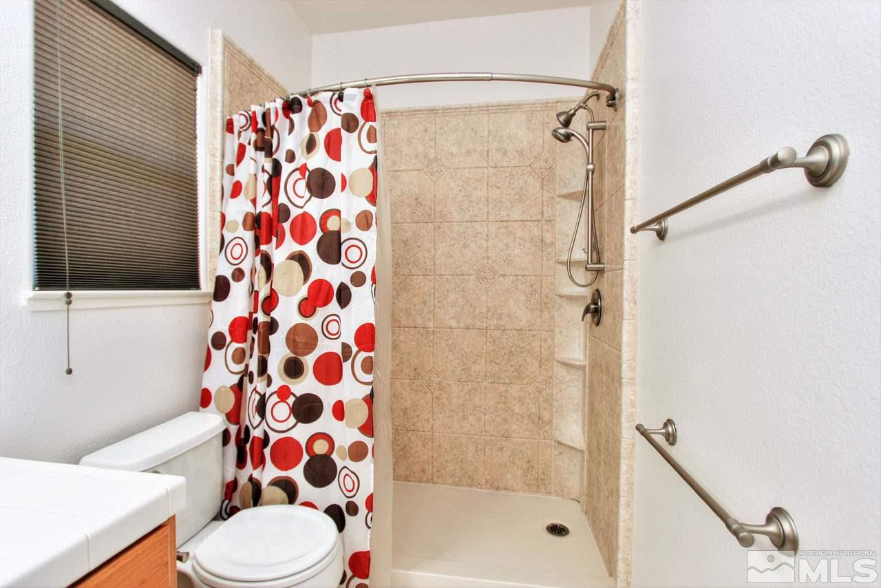 1094 University Ridge Drive Reno, NV 89512 - Photo 19 of 23 a bathroom with a bathtub and a shower