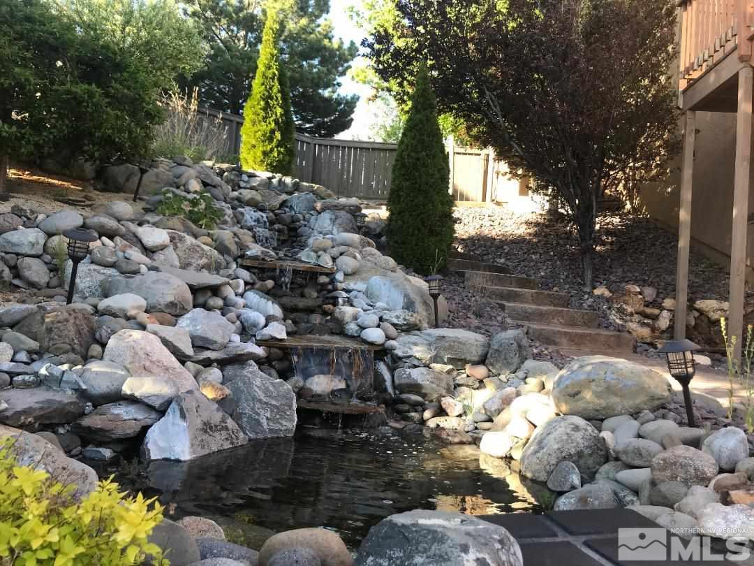 1094 University Ridge Drive Reno, NV 89512 - Photo 23 of 23 a backyard of a house with lots of green space