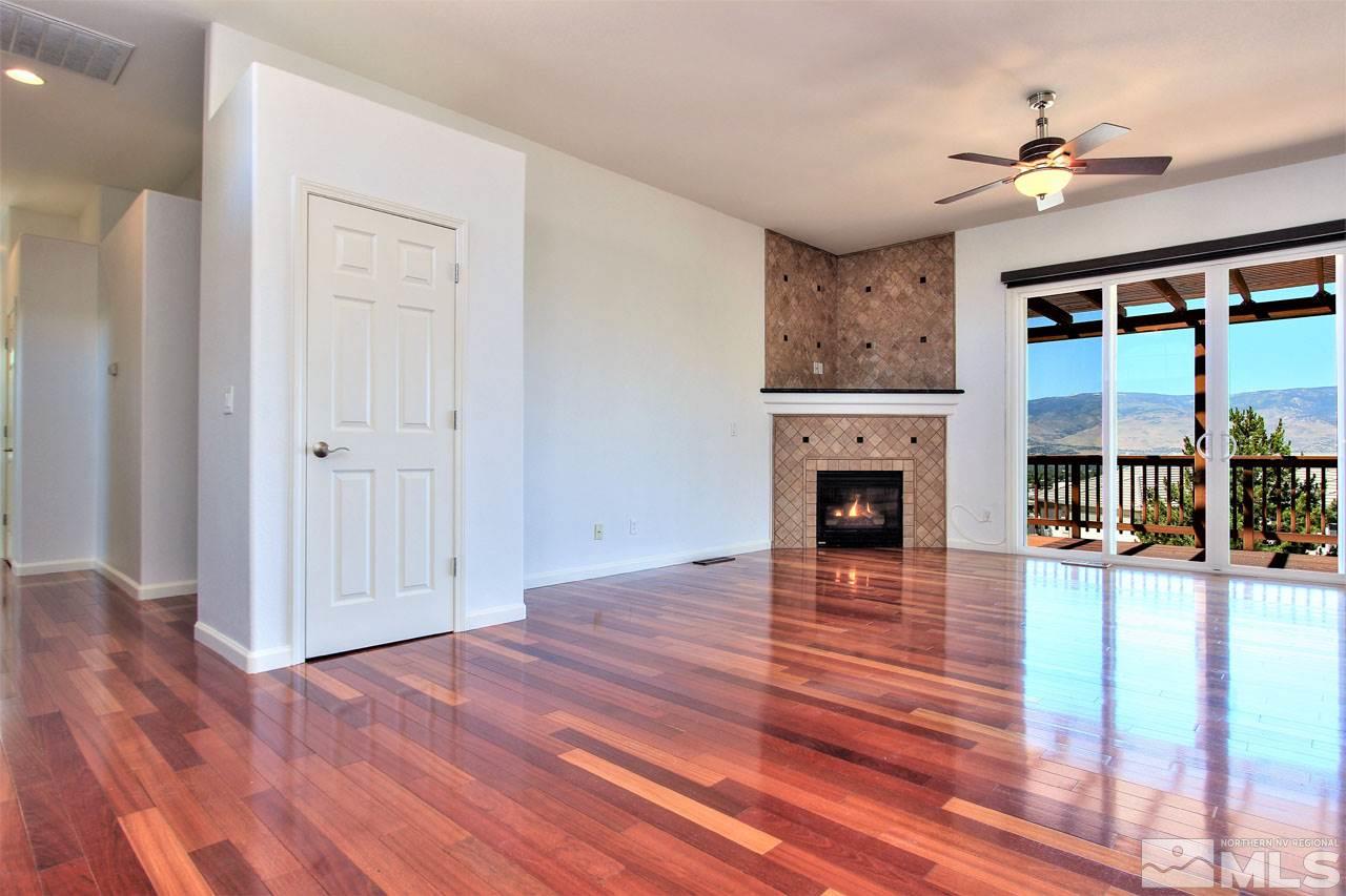 1094 University Ridge Drive Reno, NV 89512 - Photo 4 of 23 a view of a livingroom with wooden floor and a fireplace