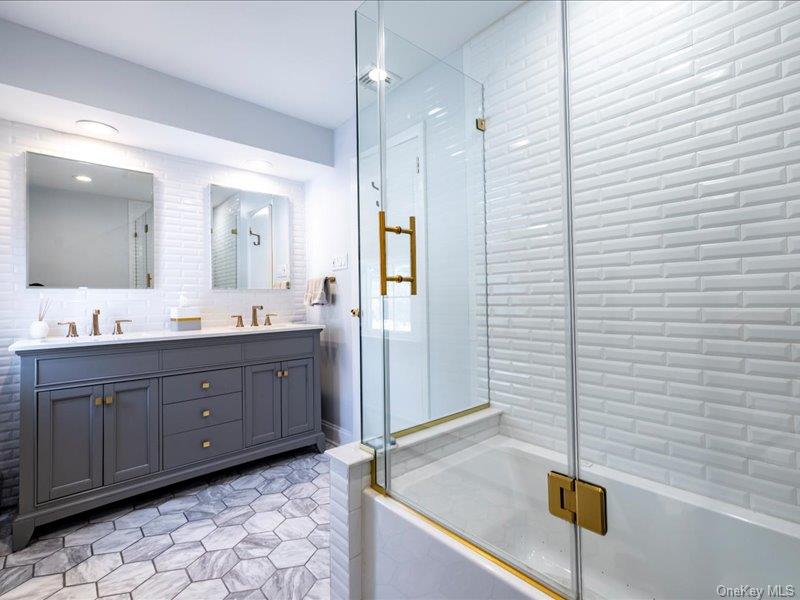 16 Wright Road Rockville Centre, NY 11570 - Photo 11 of 23 a bathroom with a sink a granite counter and a mirror