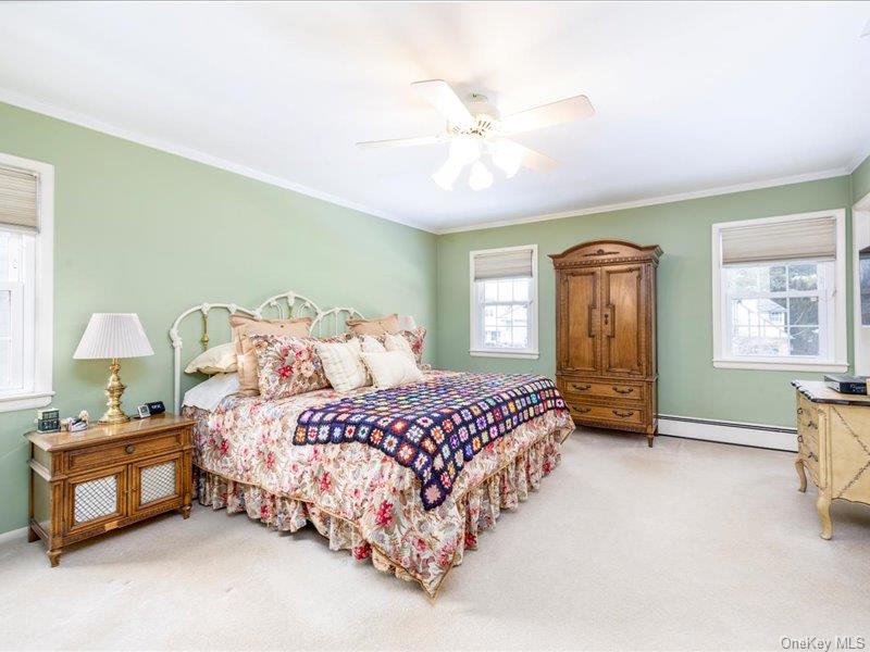 16 Wright Road Rockville Centre, NY 11570 - Photo 12 of 23 a bedroom with a bed and a chandelier