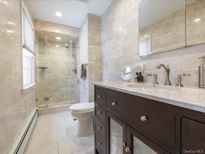 16 Wright Road Rockville Centre, NY 11570 - Photo 13 of 23 a bathroom with a sink a toilet and shower