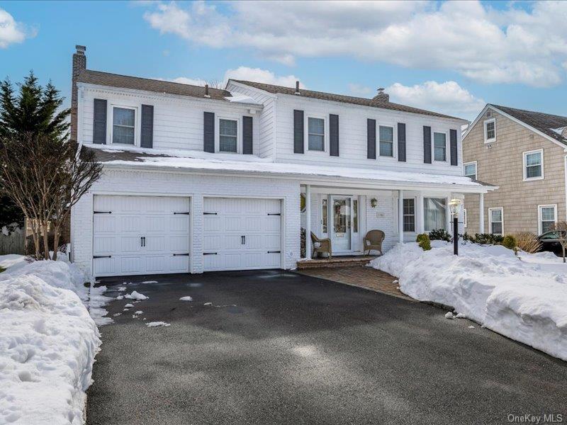 16 Wright Road Rockville Centre, NY 11570 - Photo 20 of 23 a front view of a house with a yard