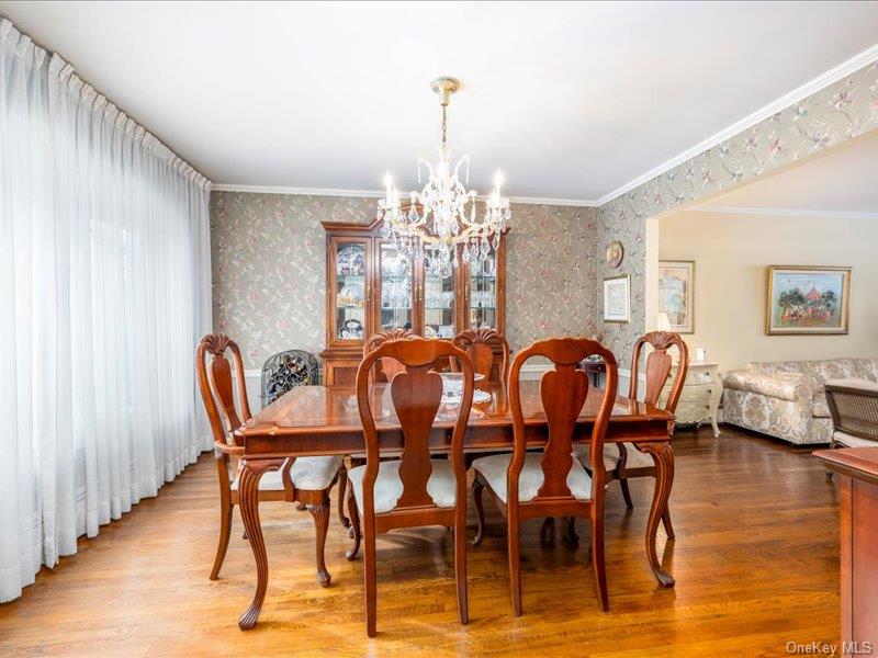 16 Wright Road Rockville Centre, NY 11570 - Photo 5 of 23 a dining room with furniture a chandelier and wooden floor