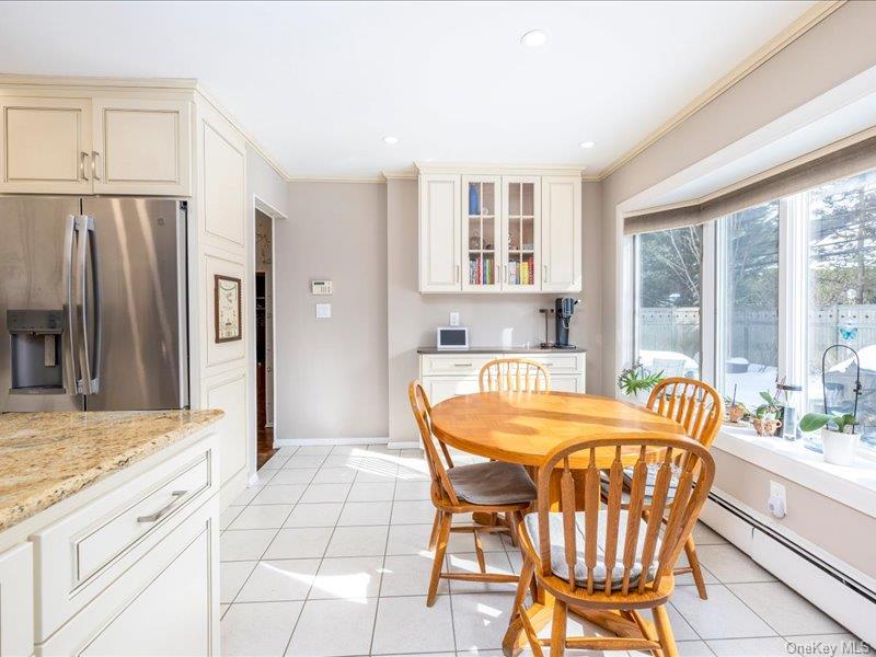 16 Wright Road Rockville Centre, NY 11570 - Photo 8 of 23 a dining room with furniture and large windows